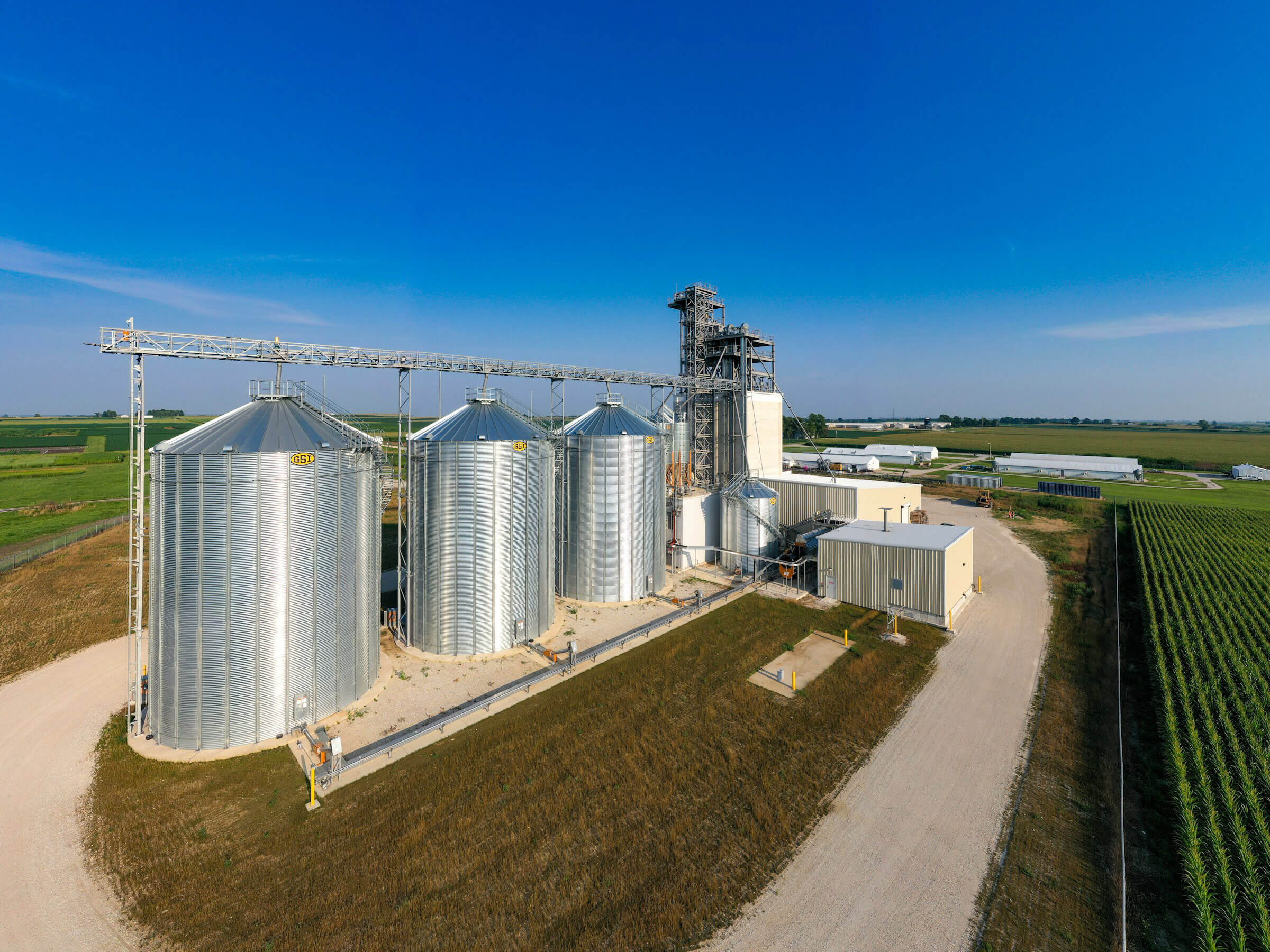 A landscape photo with a modern day farm with a grain mill