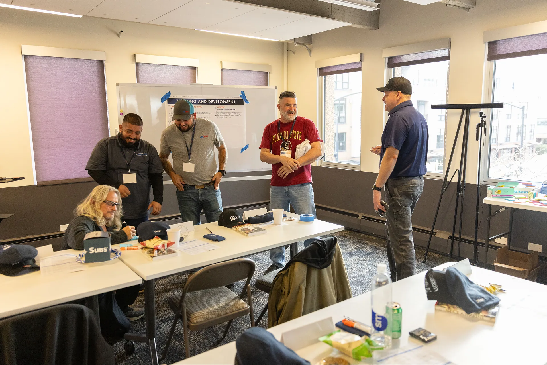 a group of adults participating in an interactive training or workshop session inside a brightly lit conference room
