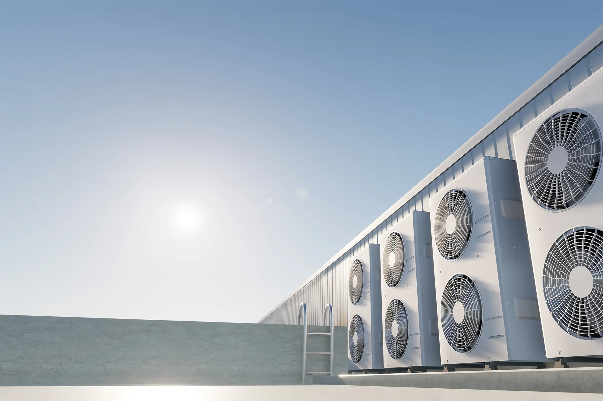 a row of large commercial rooftop HVAC (heating, ventilation, and air conditioning) condenser units installed along the edge of a flat building roof