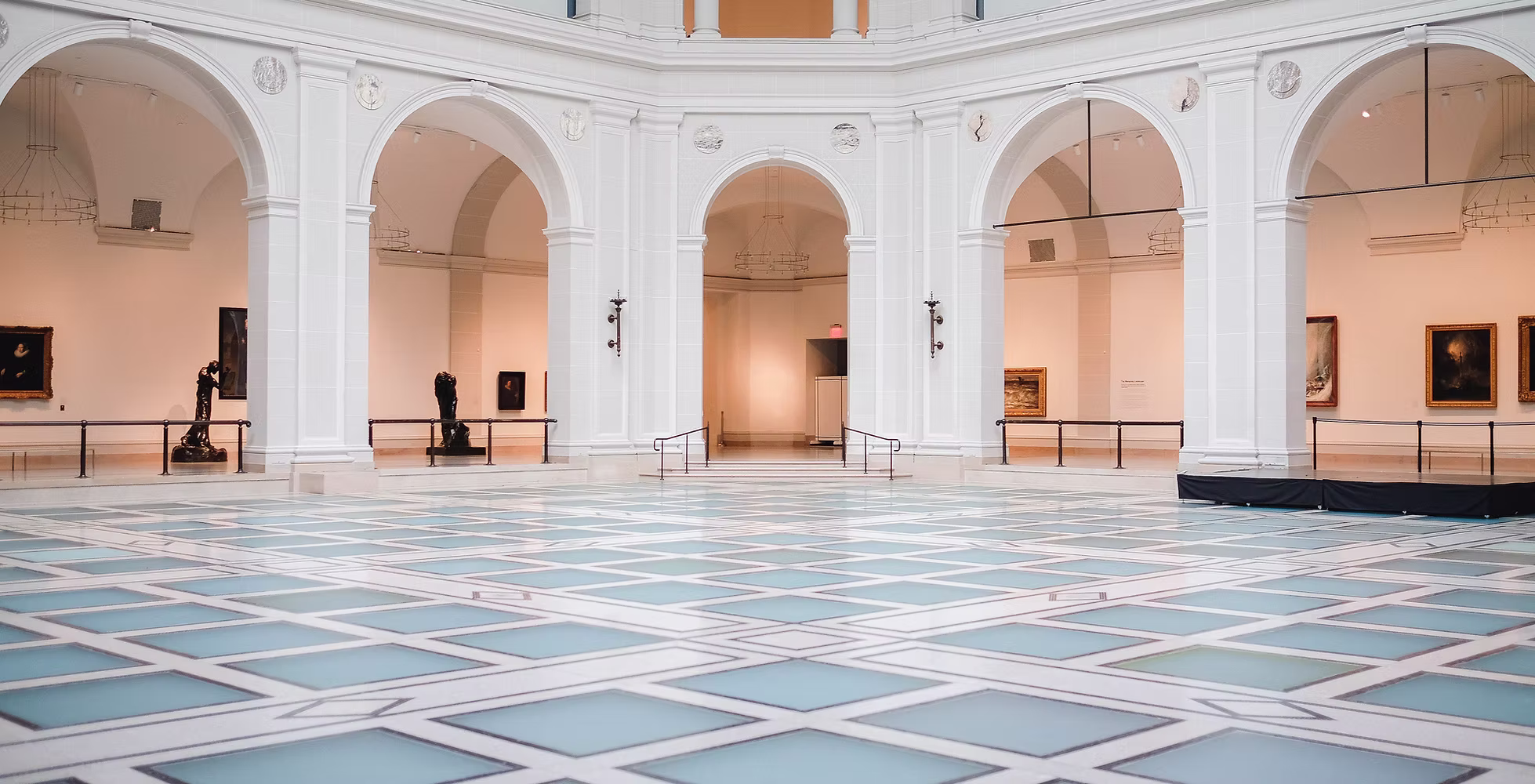 Arte Arechi, a large, open gallery interior with a striking blue and white checkered floor