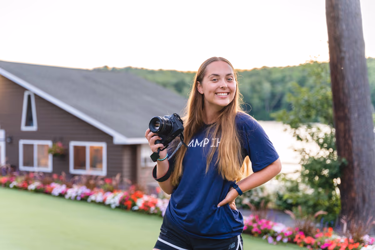 A staff member smiling at summer camp.