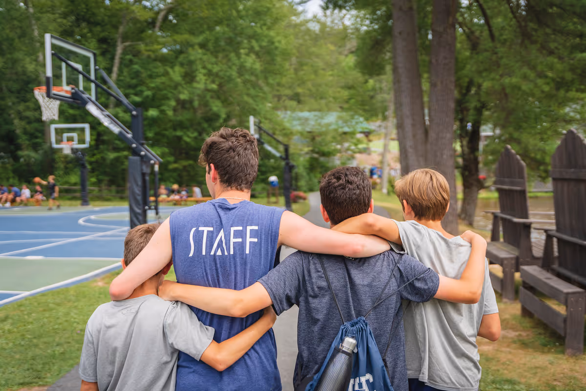 A summer camp staff member with campers.