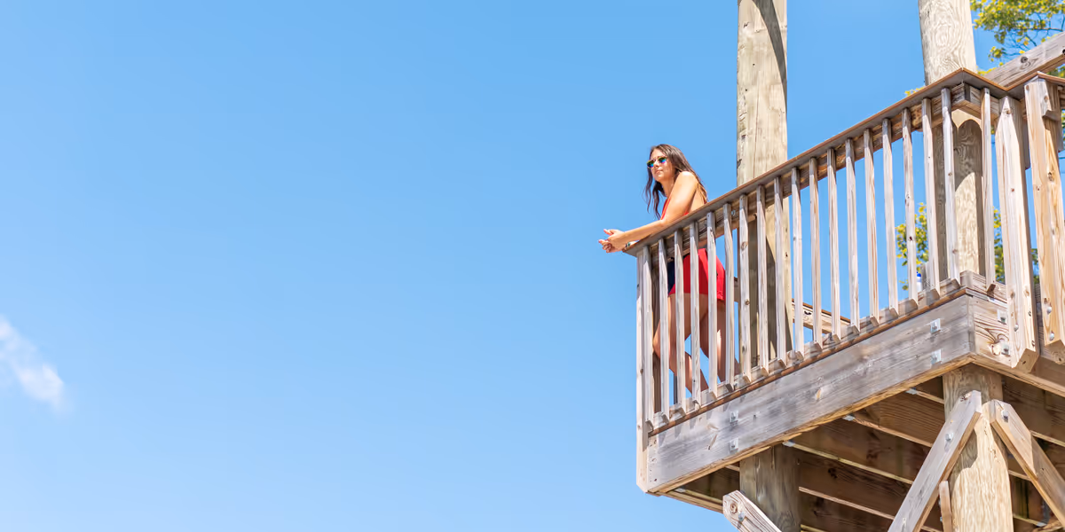 A summer camp counselor stood on some decking.