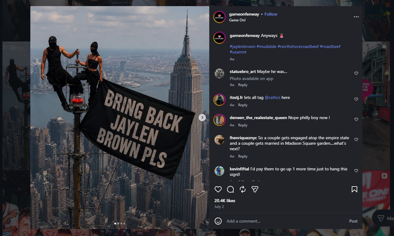 Screenshot of a meme from Game On! Fenway. Couple on Empire State Building wit a black flag; over it is text that says 'Bring Back Jaylen Brown PLS'