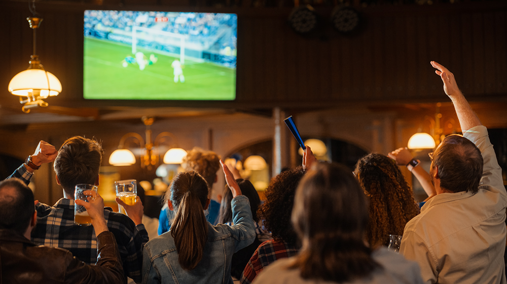 Group of sports fans watching a game at their local sports bar