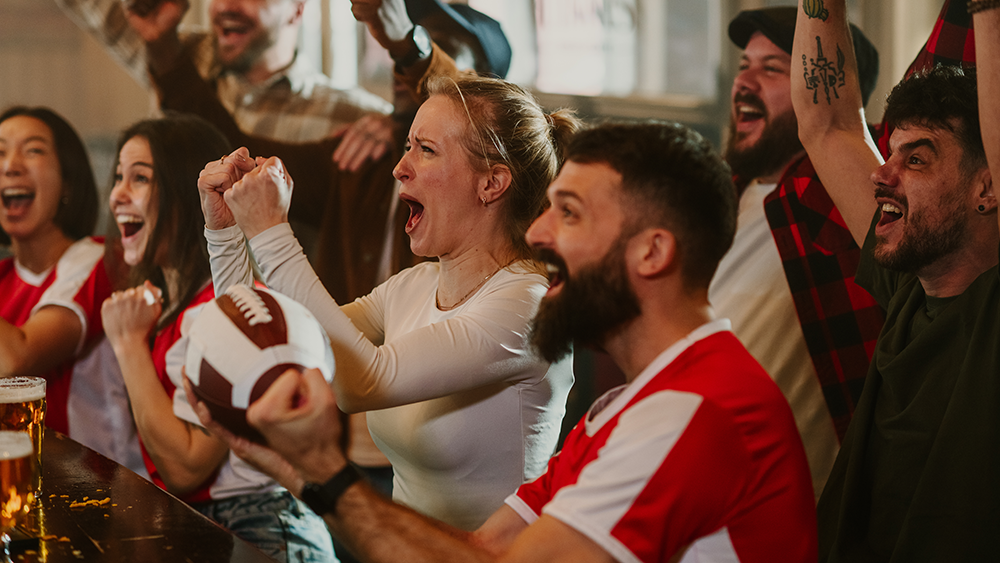 Football fans celebrate at a local sports bar