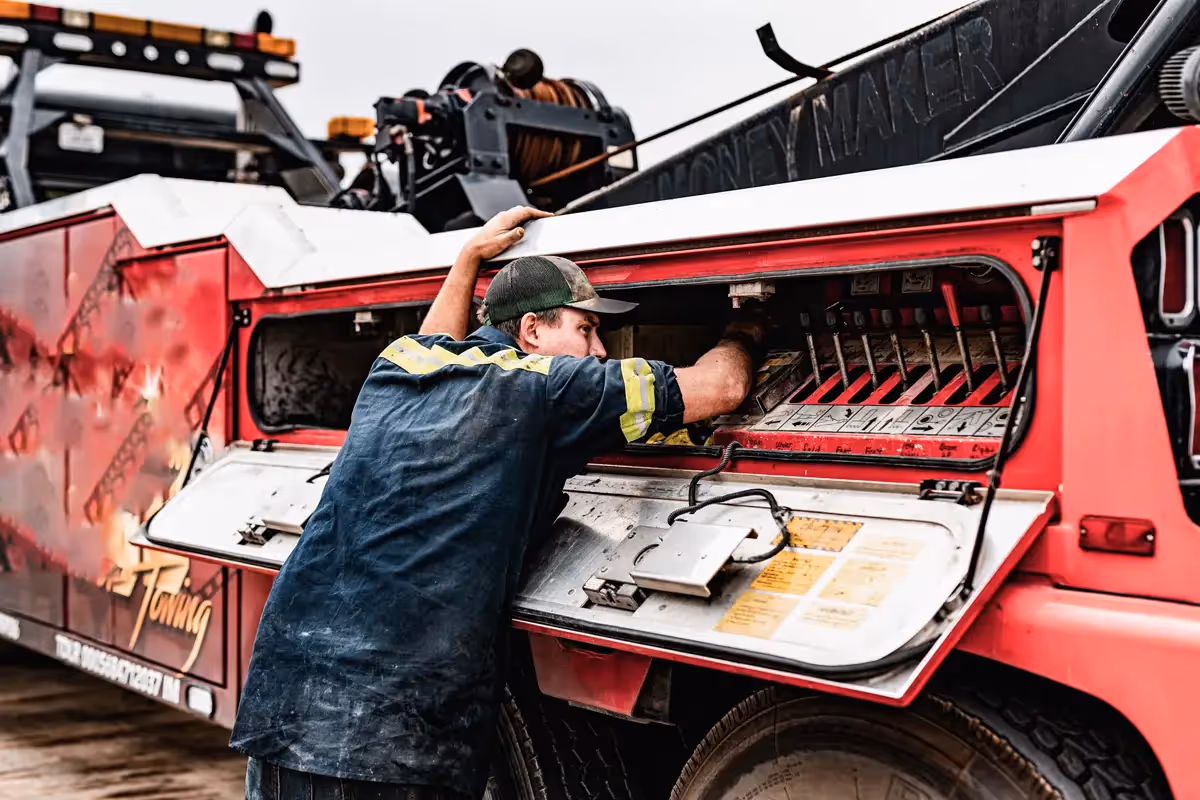 Diesel mechanic performing towing services on a commercial truck in Edmonton, AB