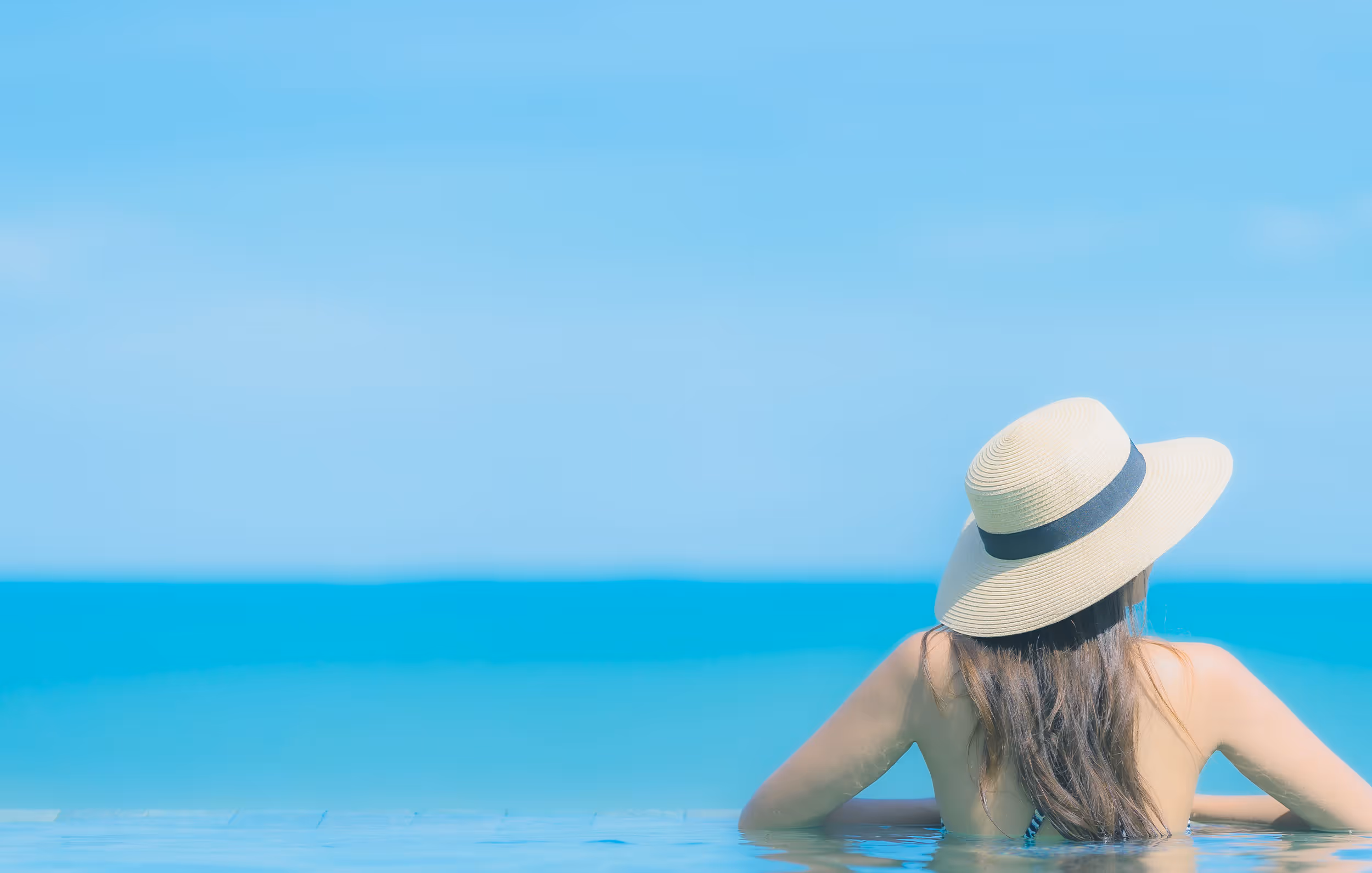 Woman in hat looking at horizon (model)