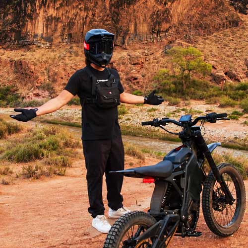 Rider drifting through red sand on the Babylon trail