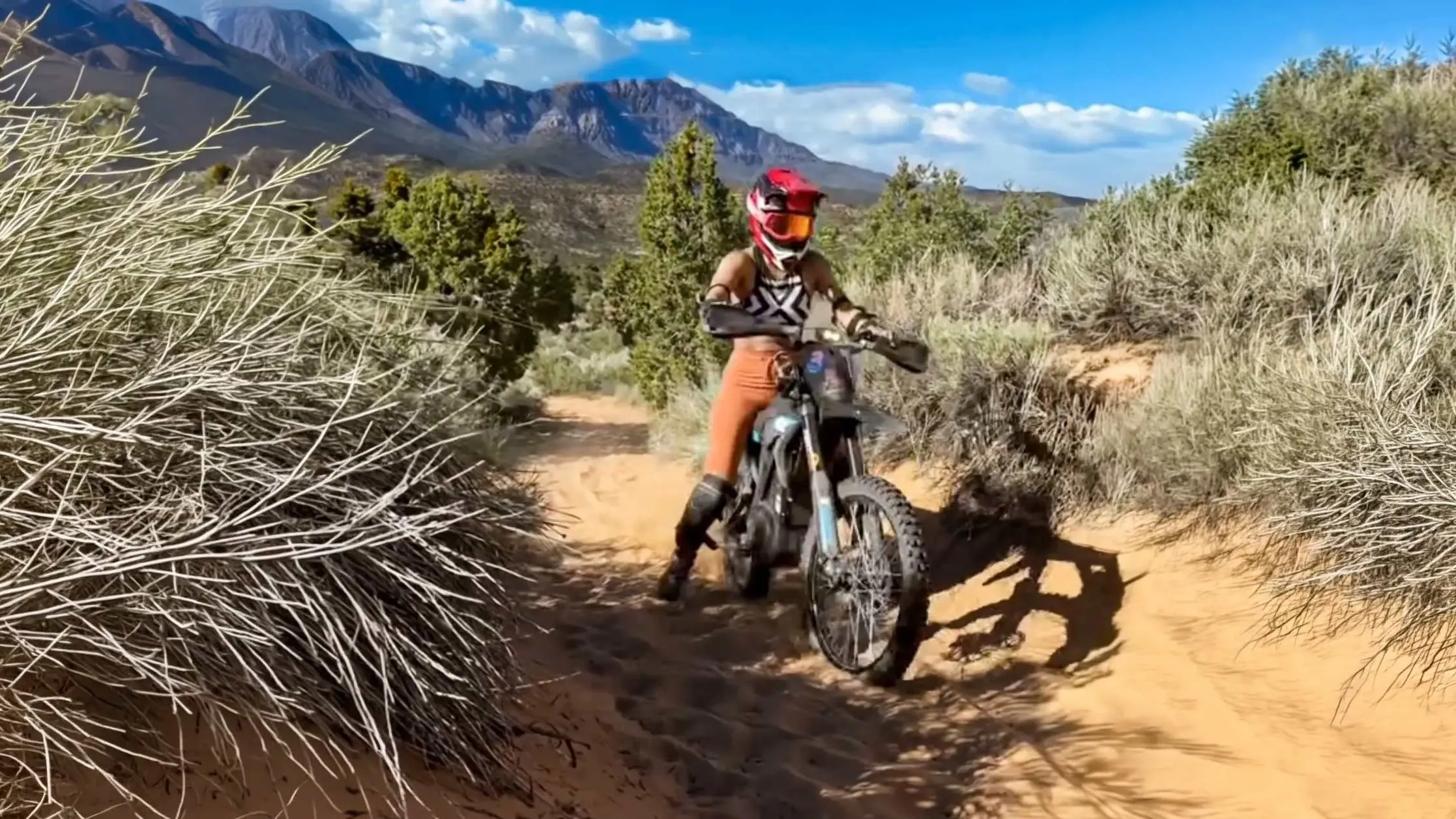 Rider on an electric dirt bike on desert terrain during the Adventure Ride