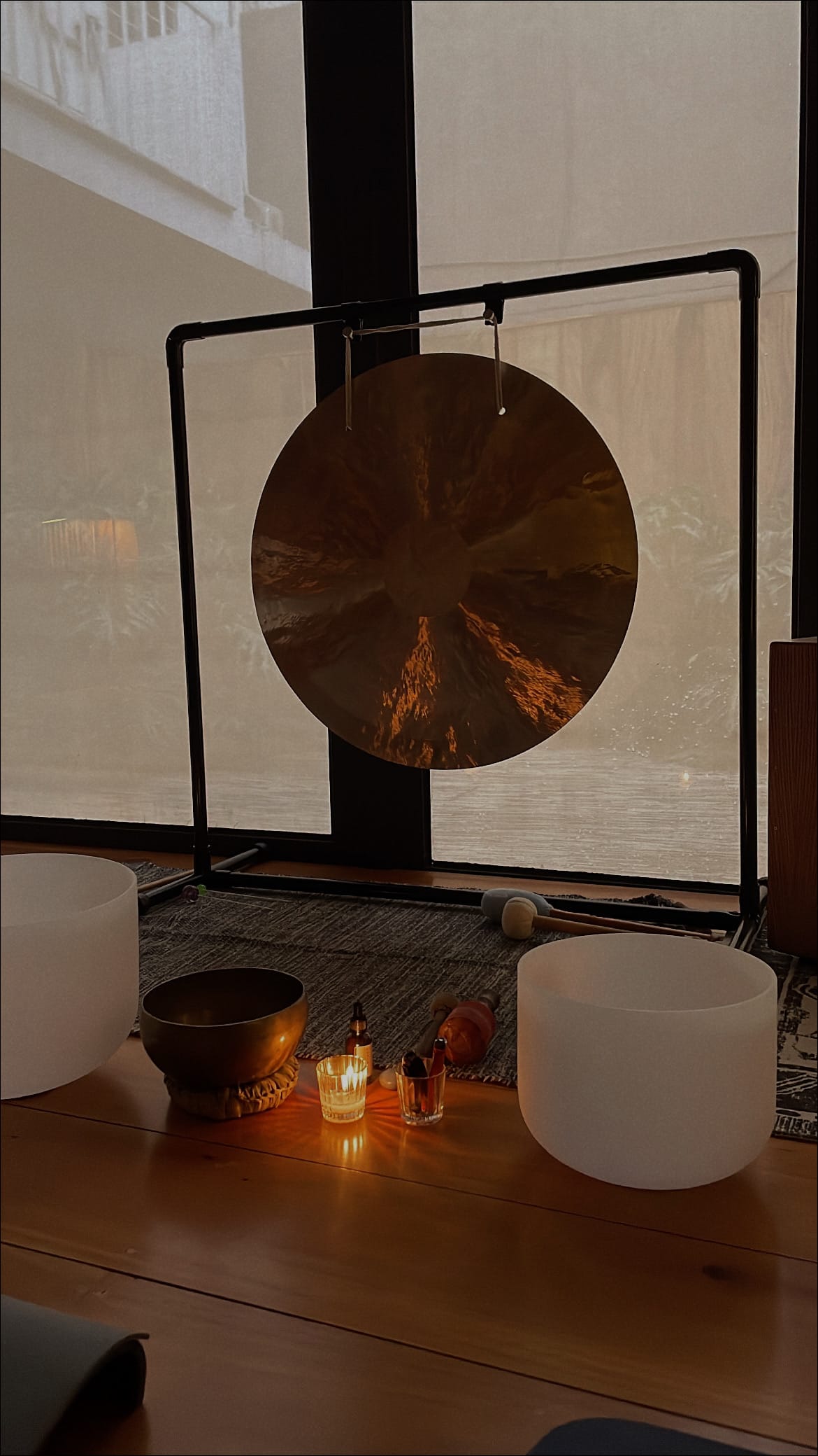 Close-up of a person’s hand typing on a laptop keyboard with another laptop blurred in the foreground.