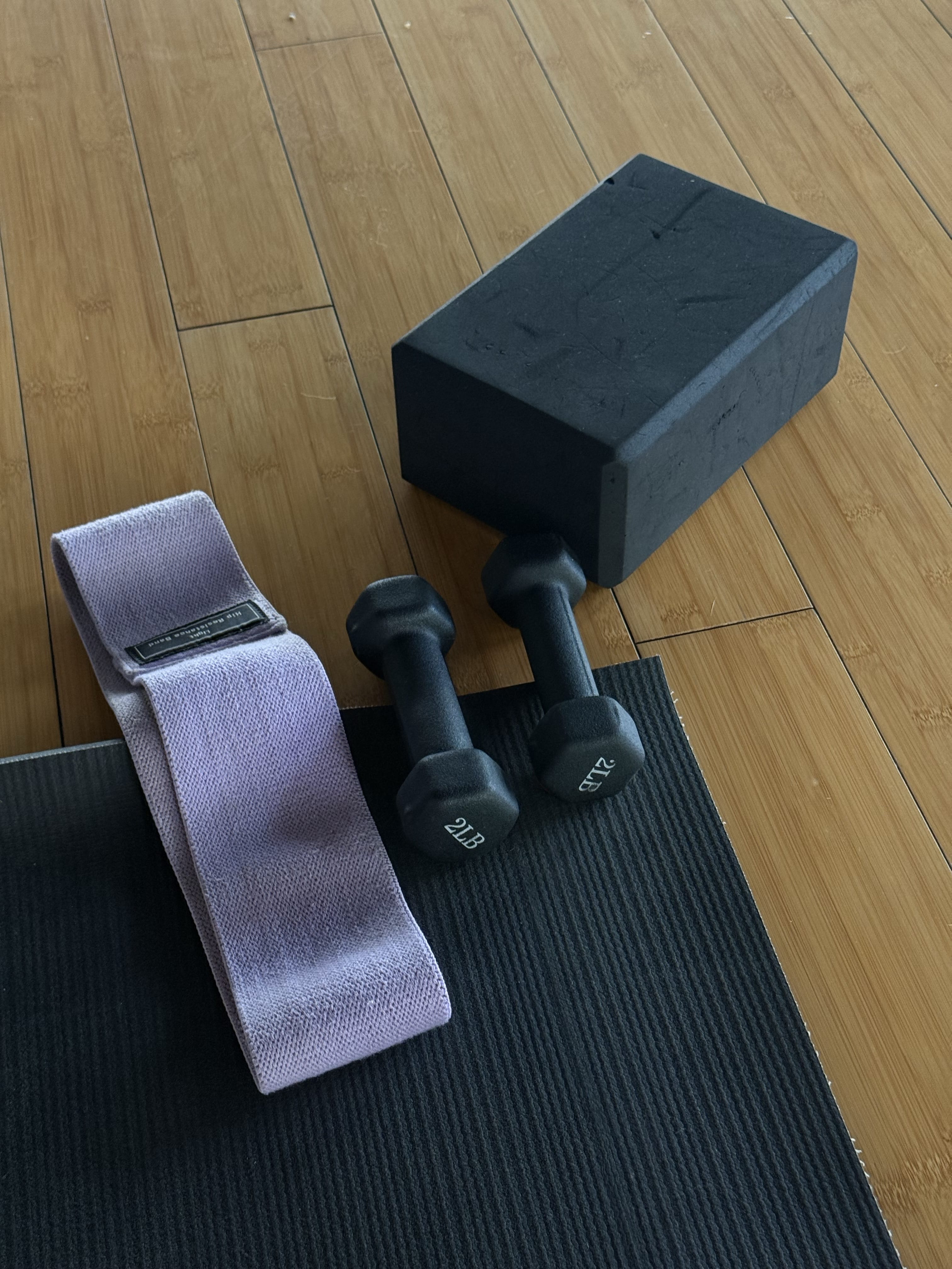 Three people sitting on blankets in a park, engaged in a friendly conversation.