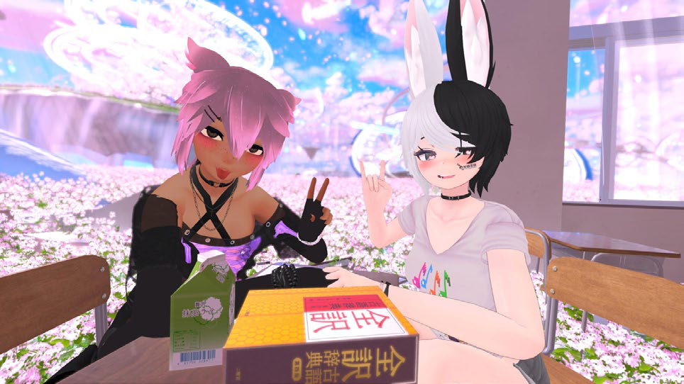 VRChat scene showing two anime-style avatars, one with cat ears and one with rabbit ears, sitting together at a table.