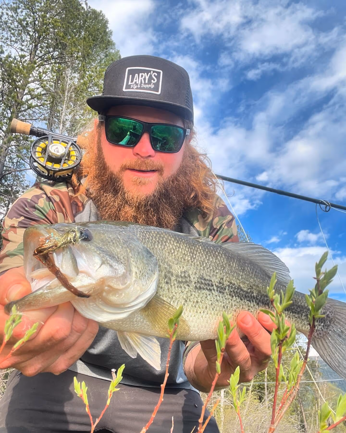 fly fishing guide holding fish
