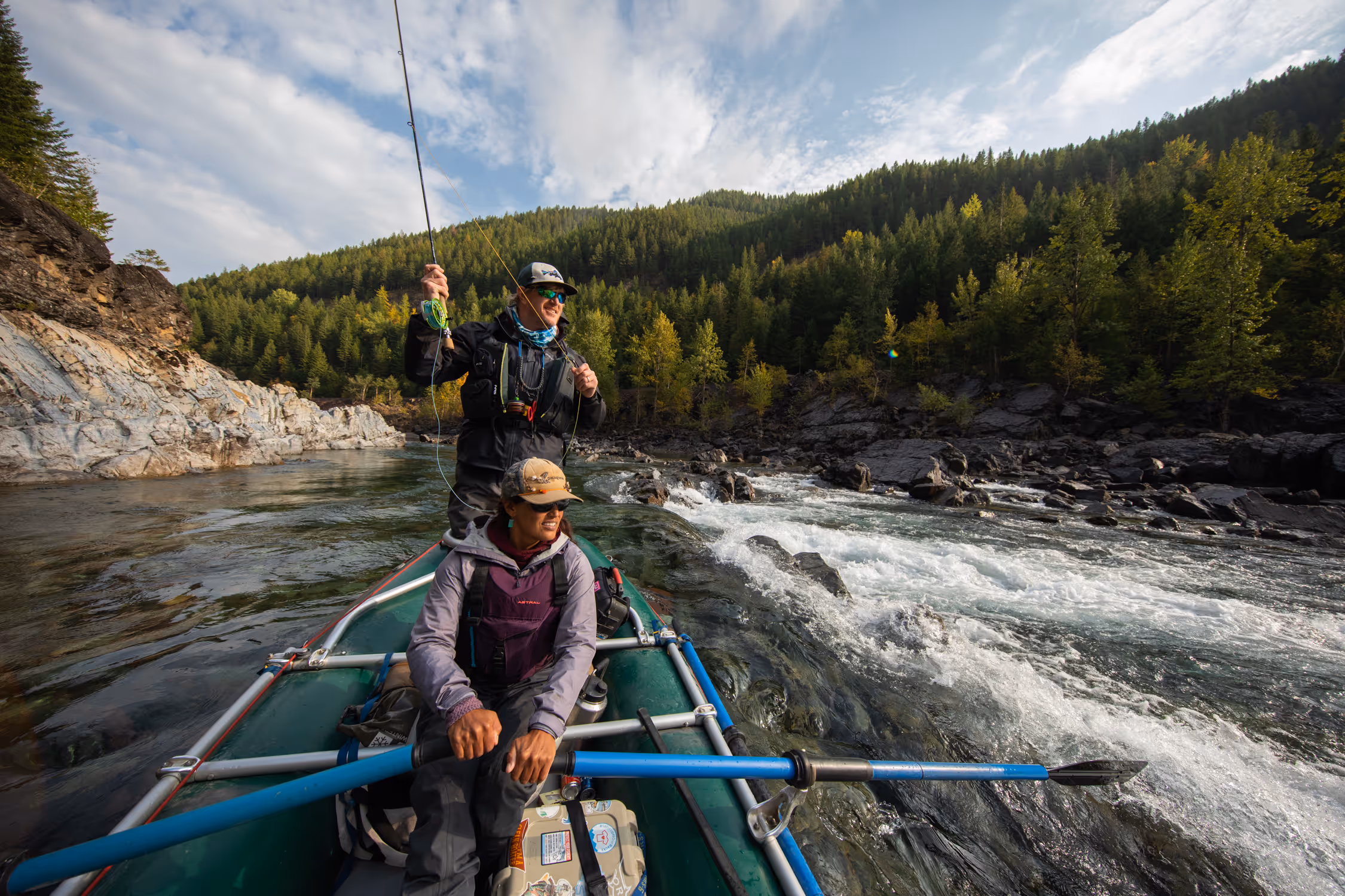 anglers fly fishing in raft on river