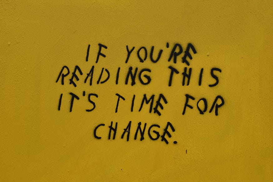 a phrase on a dark yellow background saying if you’re reading this it’s time for change