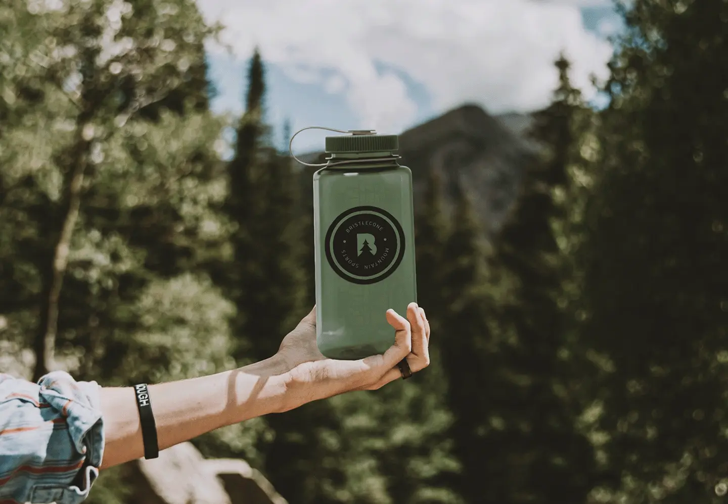 hand holding branded waterbottle