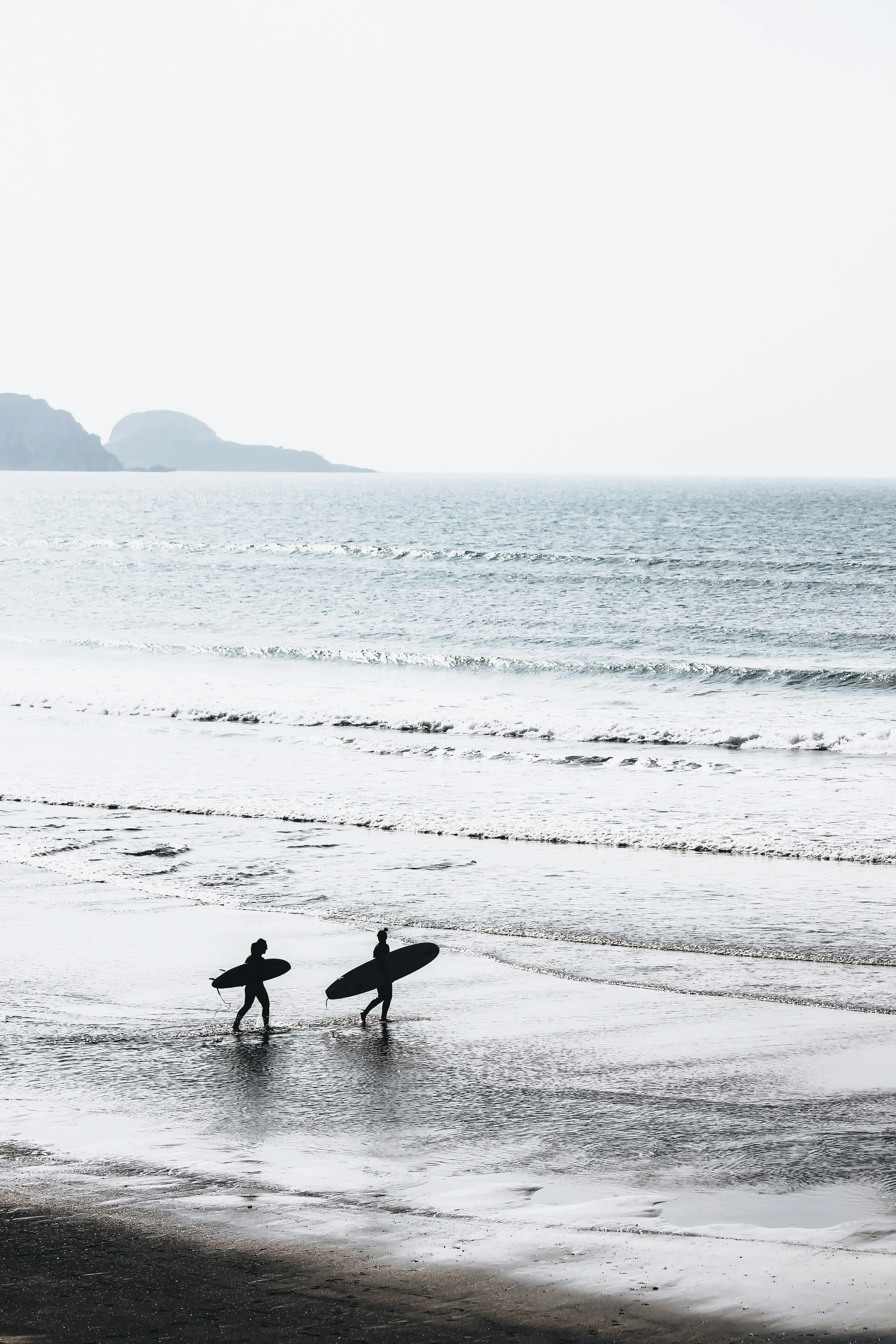 Surfer walking on a beach