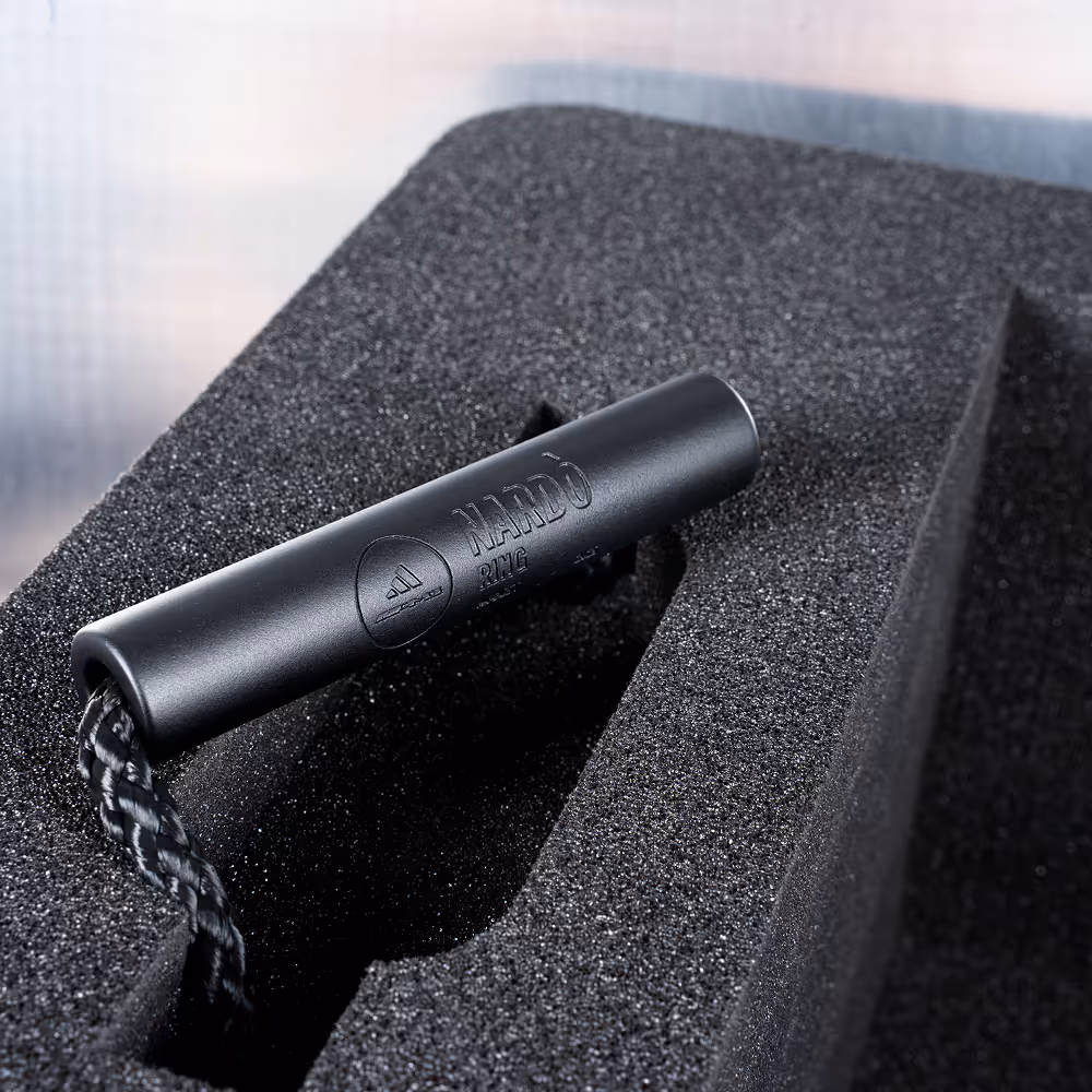 Interior view of a metal case with custom foam inserts containing rectangular compartments for secure storage of items.