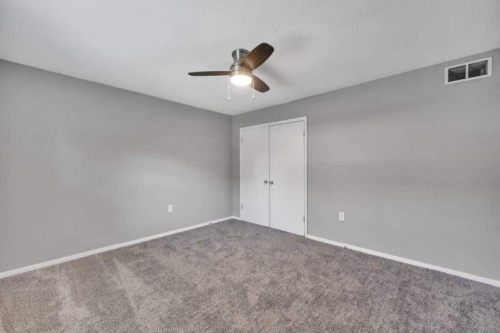 Empty closeted room with closed closet doors