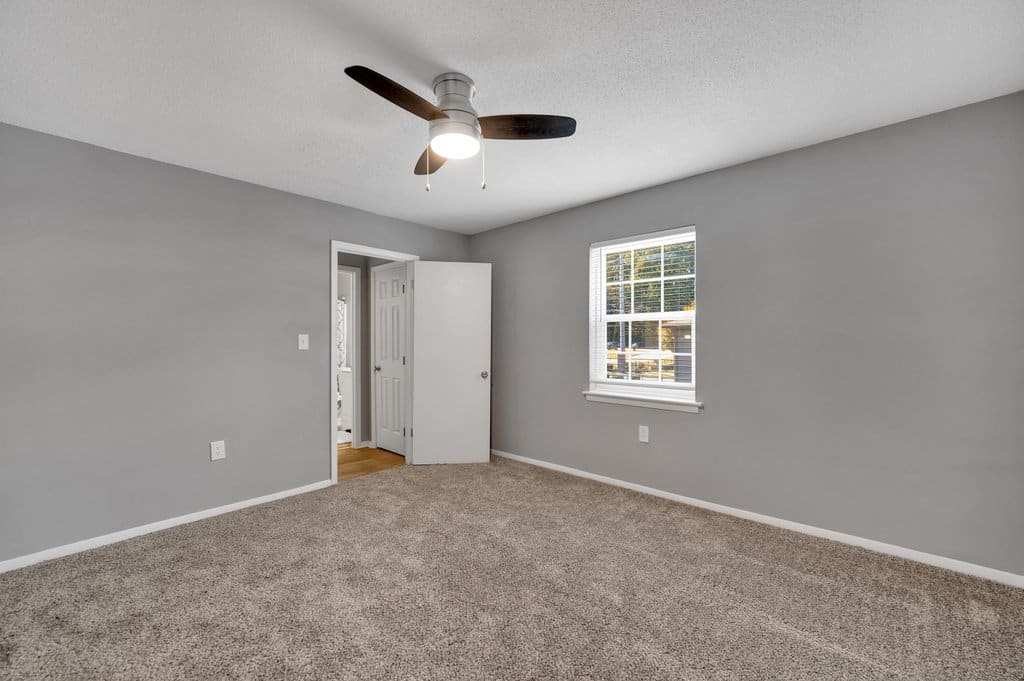 Empty closeted room with open closet doors