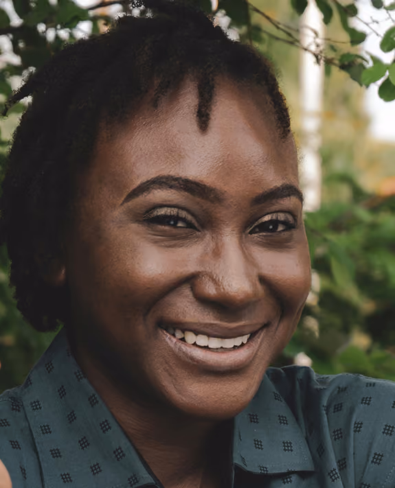 A smiling woman with a green shirt