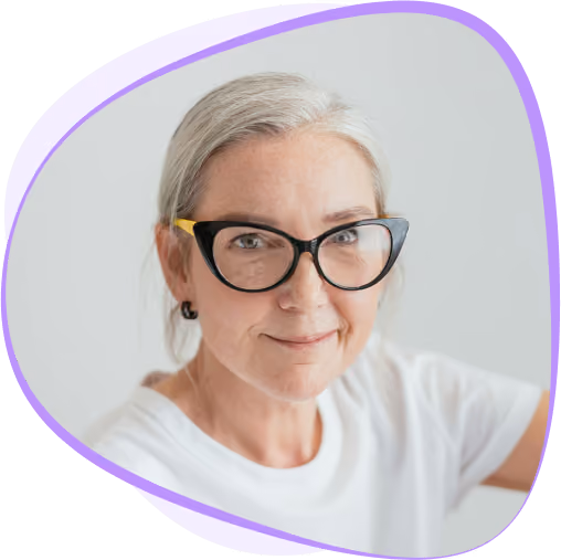 An elderly woman in white shirt wearing eyeglasses
