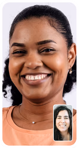 Smiling woman with dark hair in a virtual women's health video call with a smiling woman's health specialist in inset window.