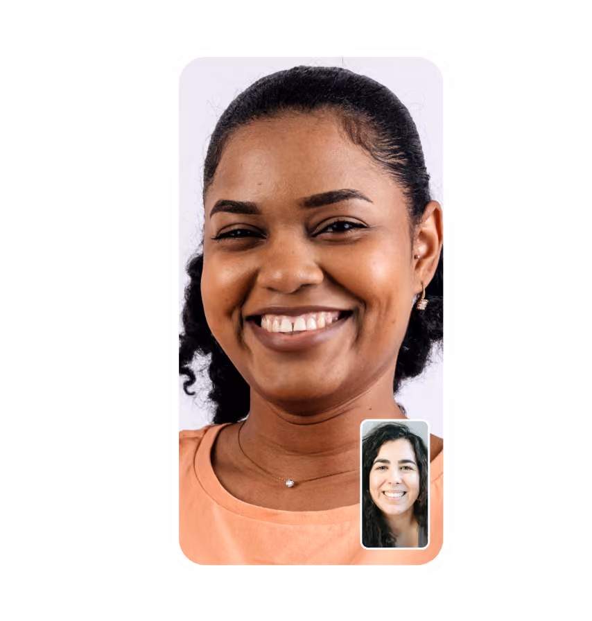 Video call screen showing a smiling woman wearing peach shirt with a smaller window of another smiling woman.