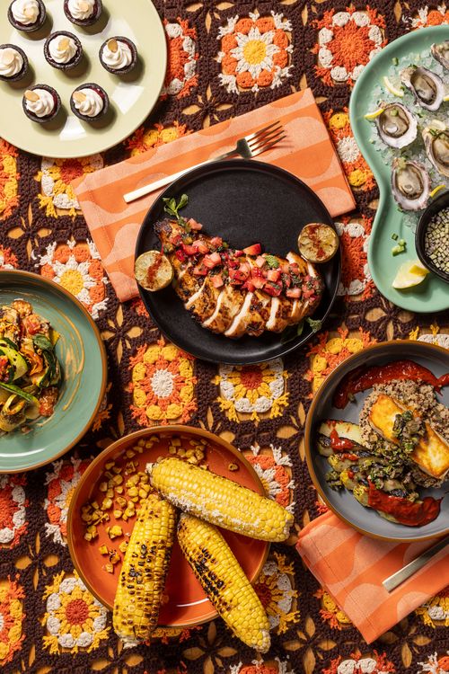 Seasonal Summer menu spread on bold table for a Seattle event by Tuxedos & Tennis Shoes Catering, a DSquared Hospitality Company