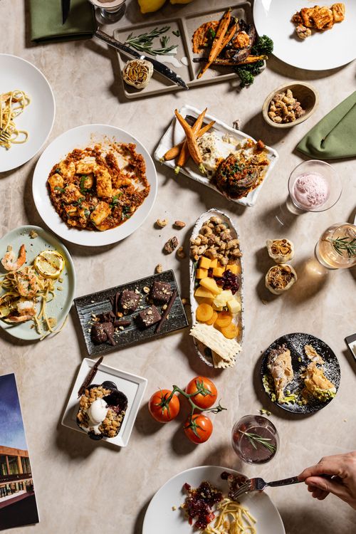 A spread of seasonal, farm-to-table entrees and side dishes at Muse at Benaroya Hall in Seattle, a DSquared Hospitality Company