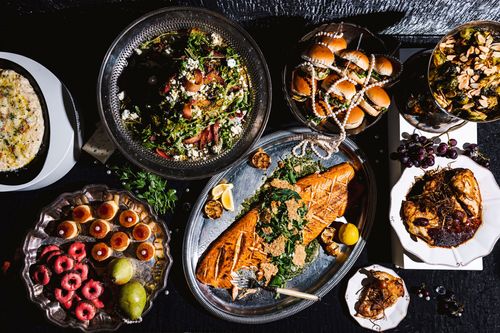 A winter holiday table with wild caught salmon and seasonal fare from Tuxedos & Tennis Shoes Catering, a DSquared Hospitality Company
