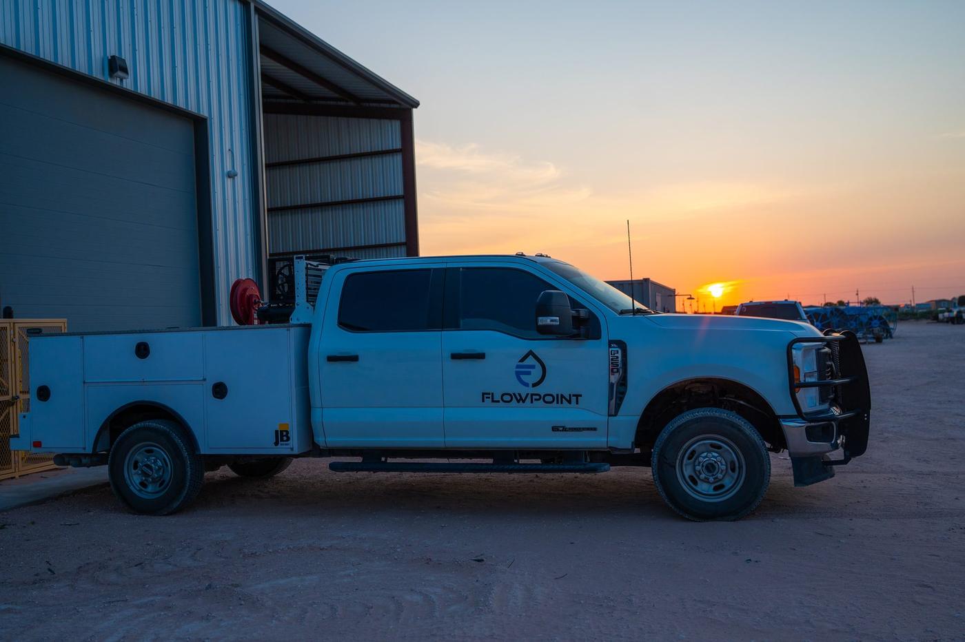 Flowpoint service truck outside the Midland shop at sunset