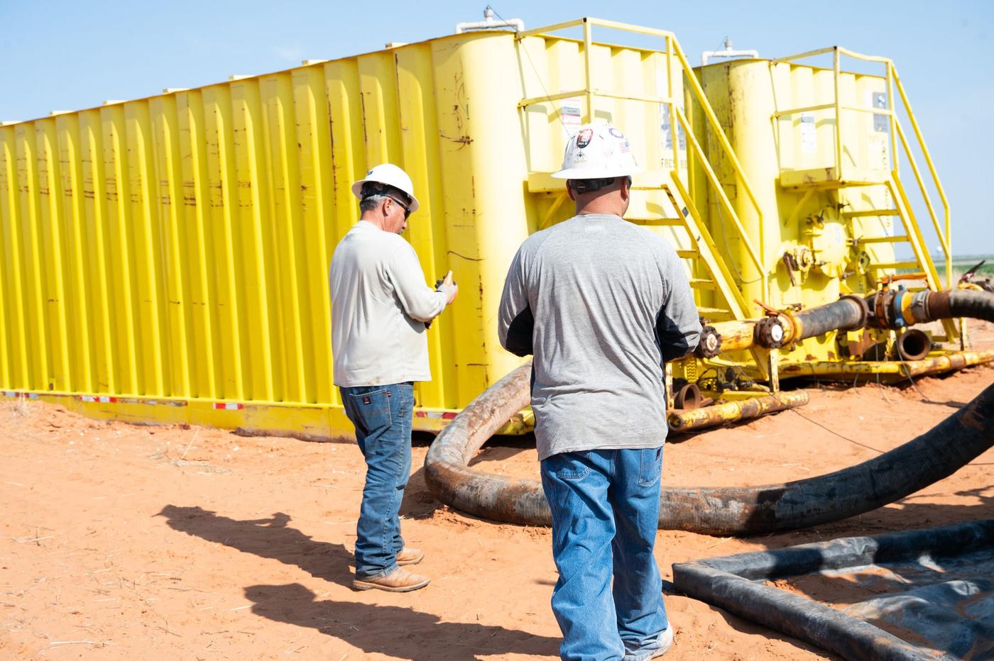Flowpoint crew working at above ground storage tanks on location