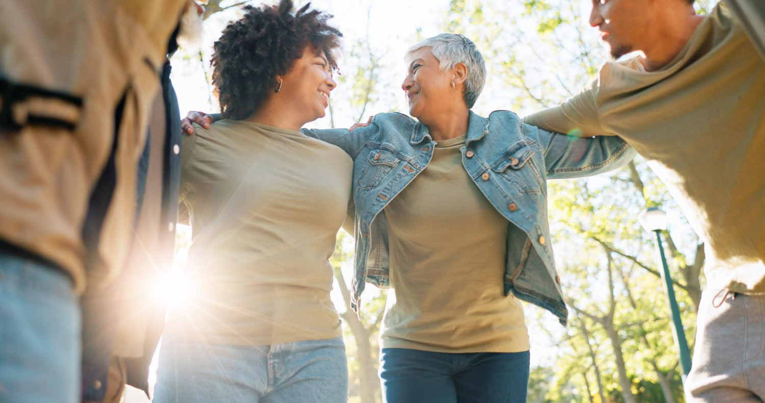 Three friends walking by the river and smiling, highlighting friendship and healing through diverse addiction treatment programs in Portland