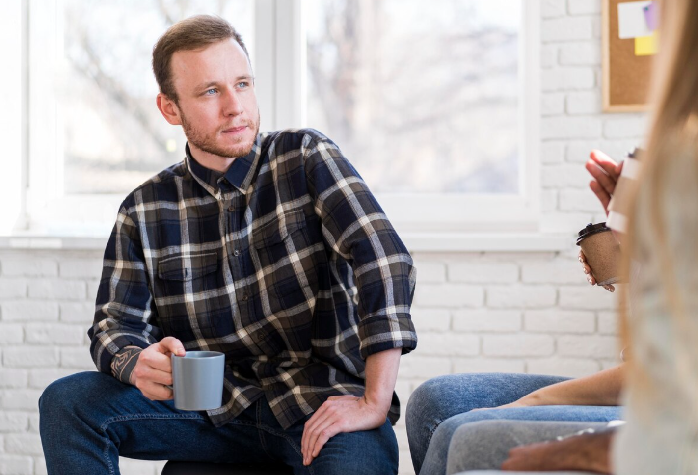 Man speaking with a counselor during a therapy session, representing treatment and support during rehab