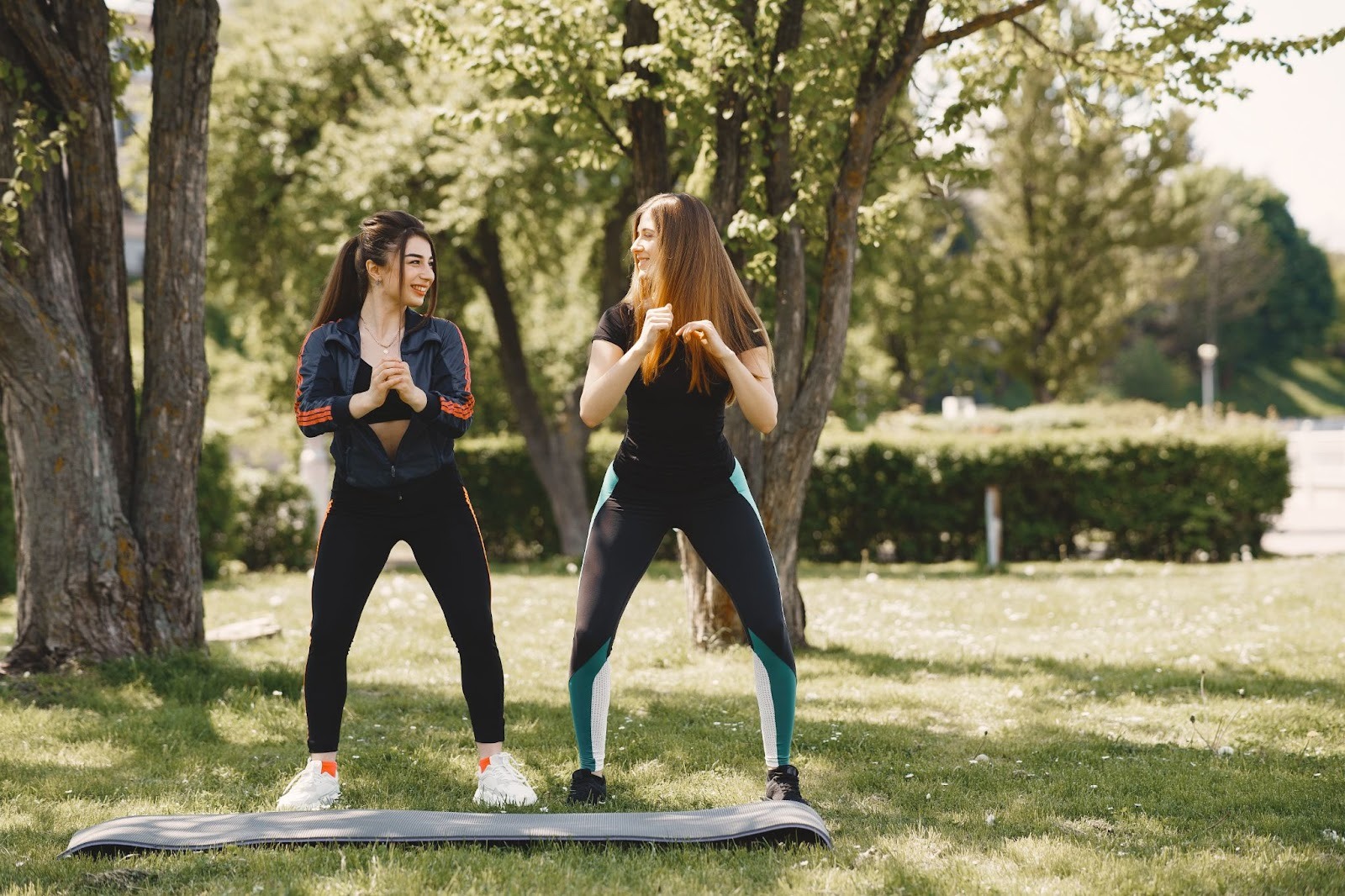 Two women staying active outdoors and building healthy routines while in a sober living home