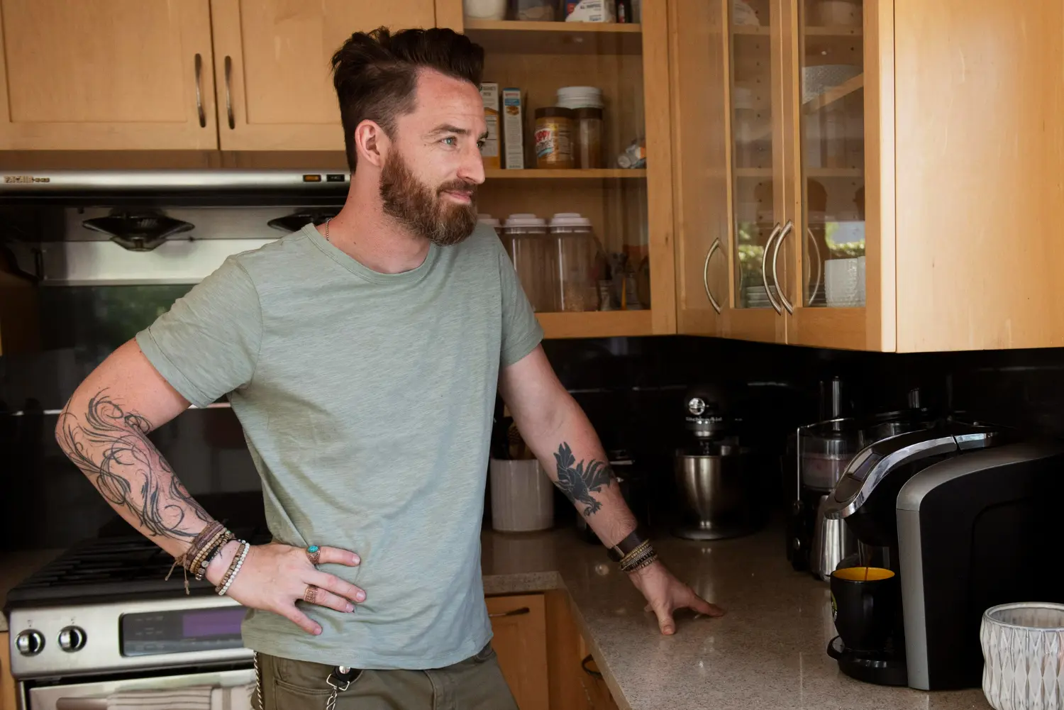 Man standing in his kitchen during daily life while receiving outpatient addiction treatment