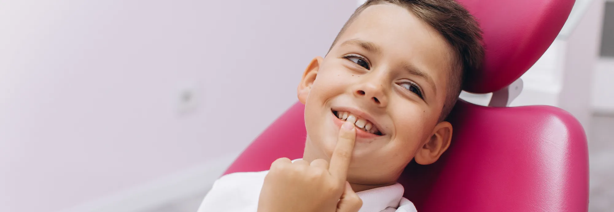 Young boy smiles in the dentist chair during an orthodontic evaluation at the top dentist in San Jose
