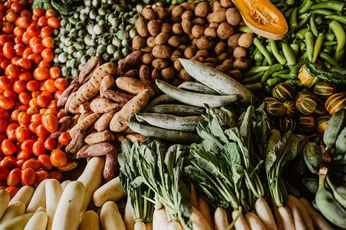 A variety of vegetables are displayed on a table.