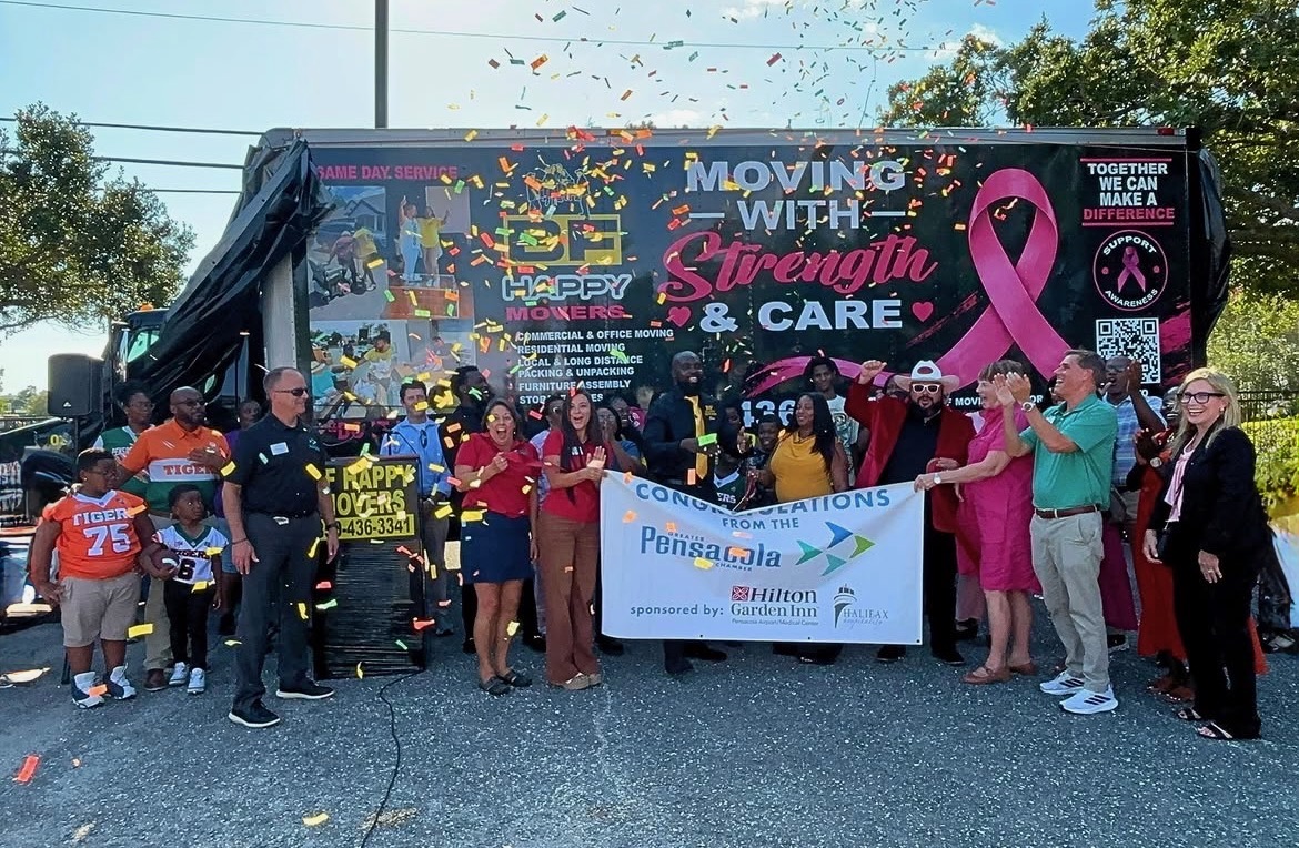 BF Happy Movers team and community guests celebrate the Greater Pensacola Chamber ribbon cutting in front of the company’s Breast Cancer Awareness moving truck
