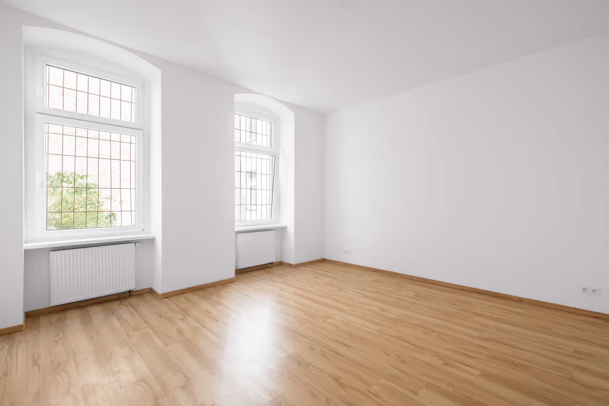 An empty living room space that has been painted white.