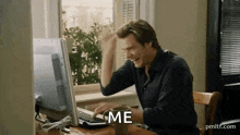 Jim Carrey typing furiously at a computer keyboard