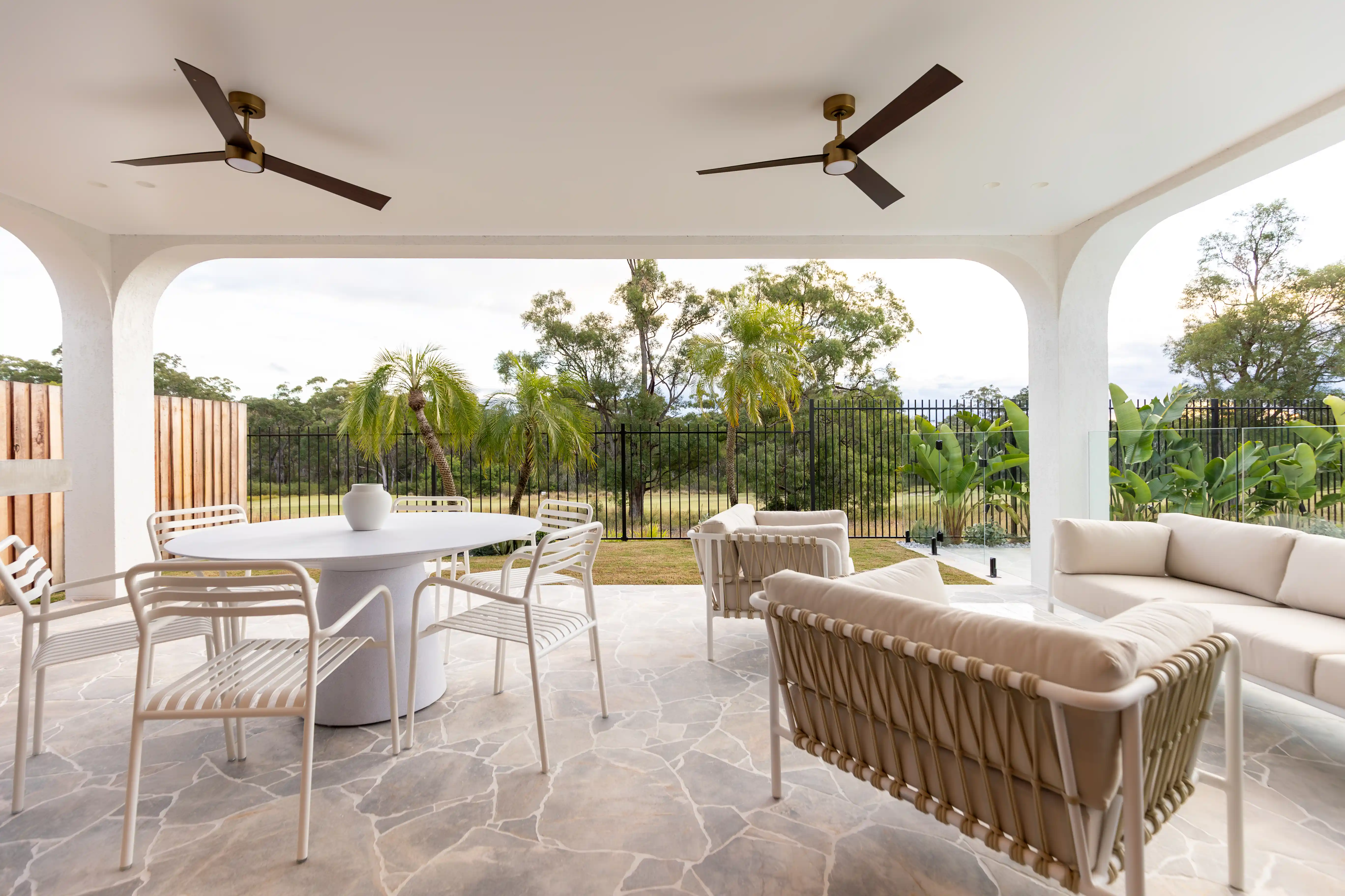 Outdoor living entertainment area. Showcasing Lounging area, table seating area and view of golf course