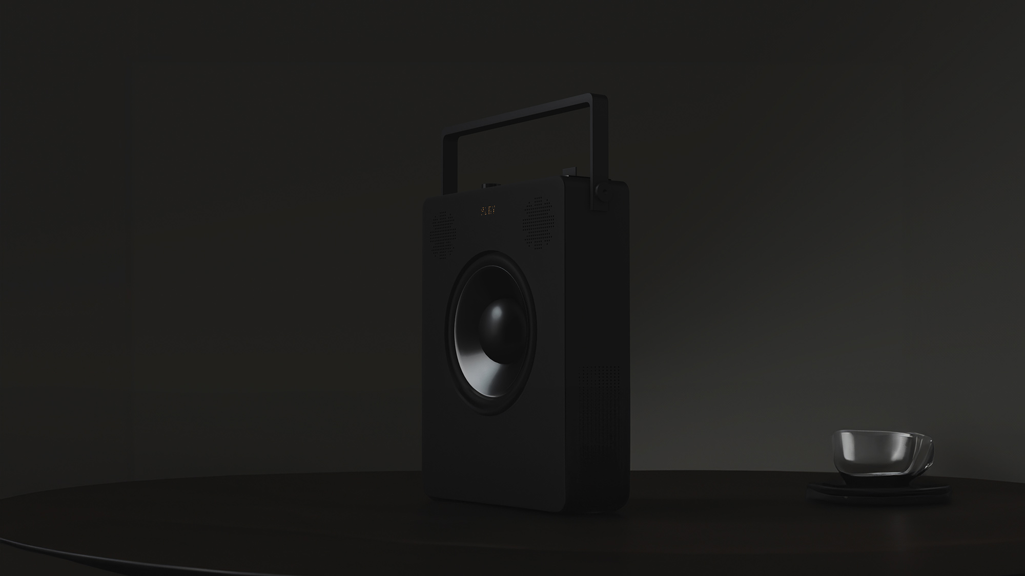 speaker on a table next to a glass