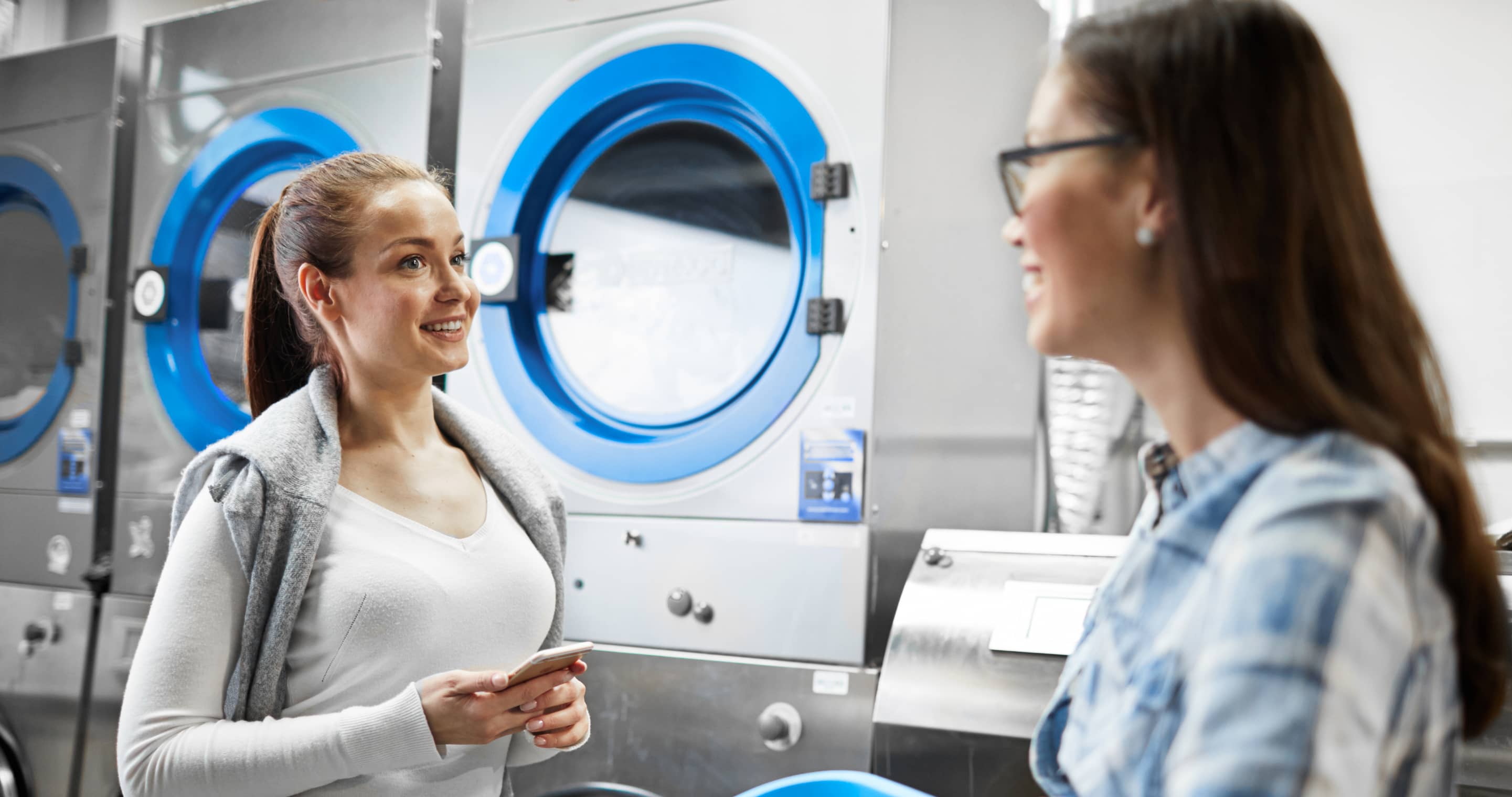 About Our Laundromat Two People Talk - Laundry X Webflow Template