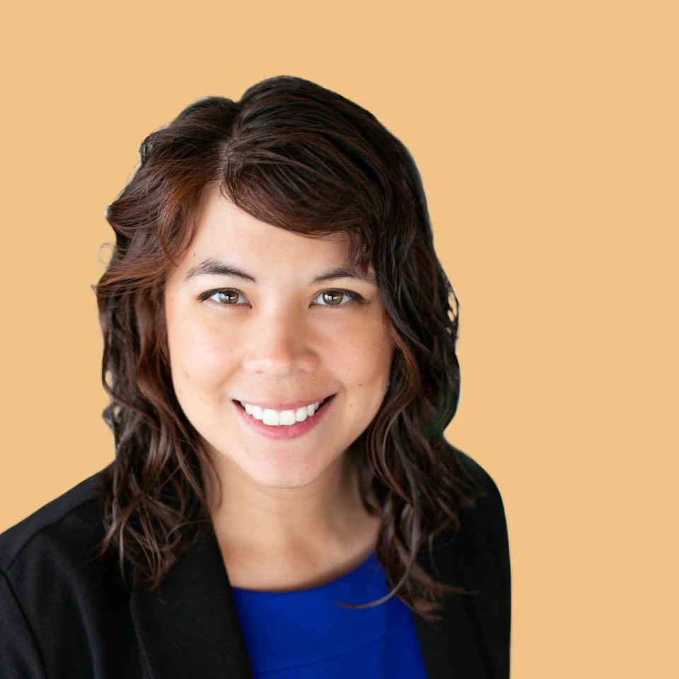 A woman looking at the camera and smiling. 