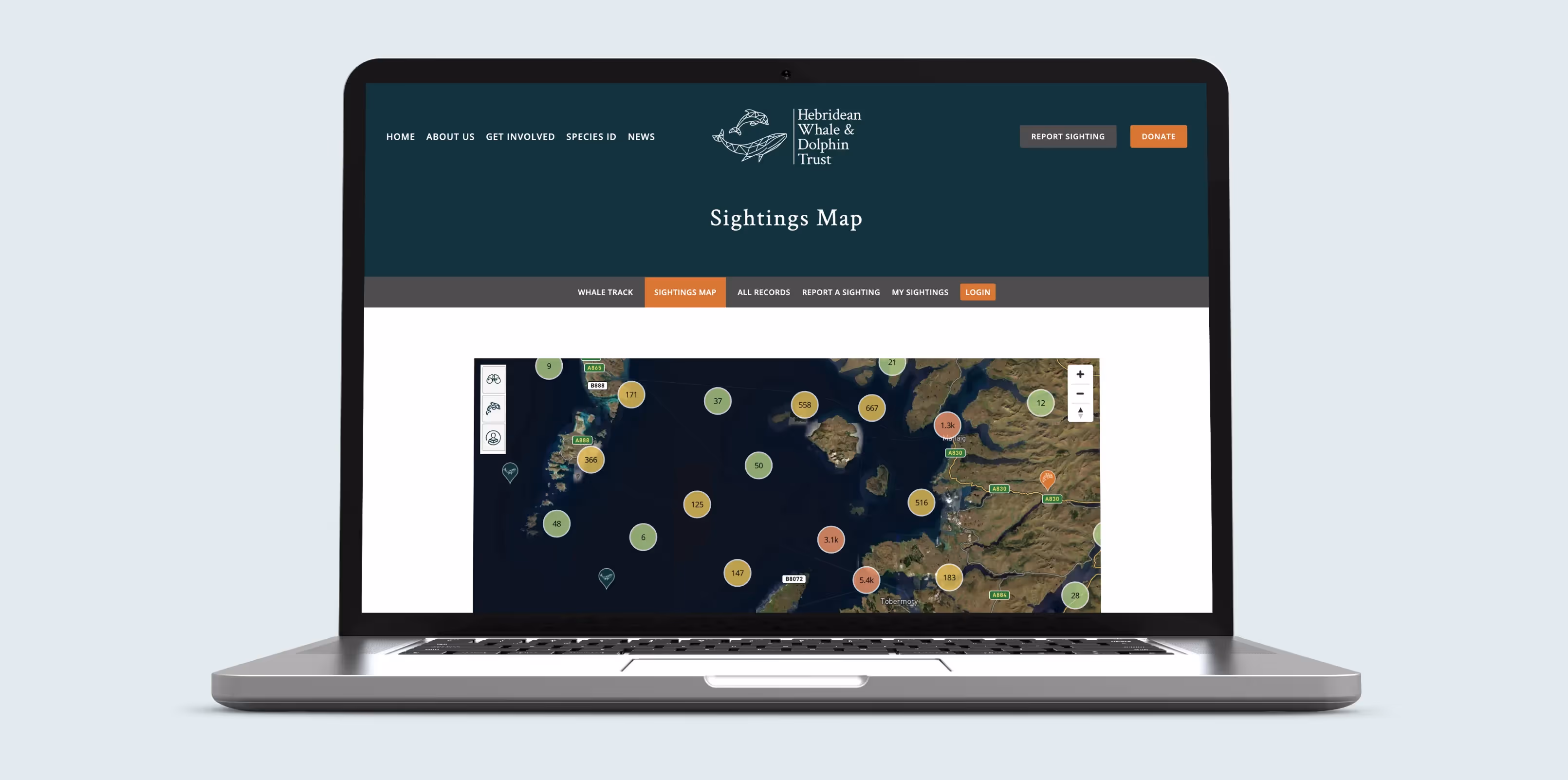 A laptop with a screenshot of the Whale Tracker app, showing a map with Whale sighting on it. 