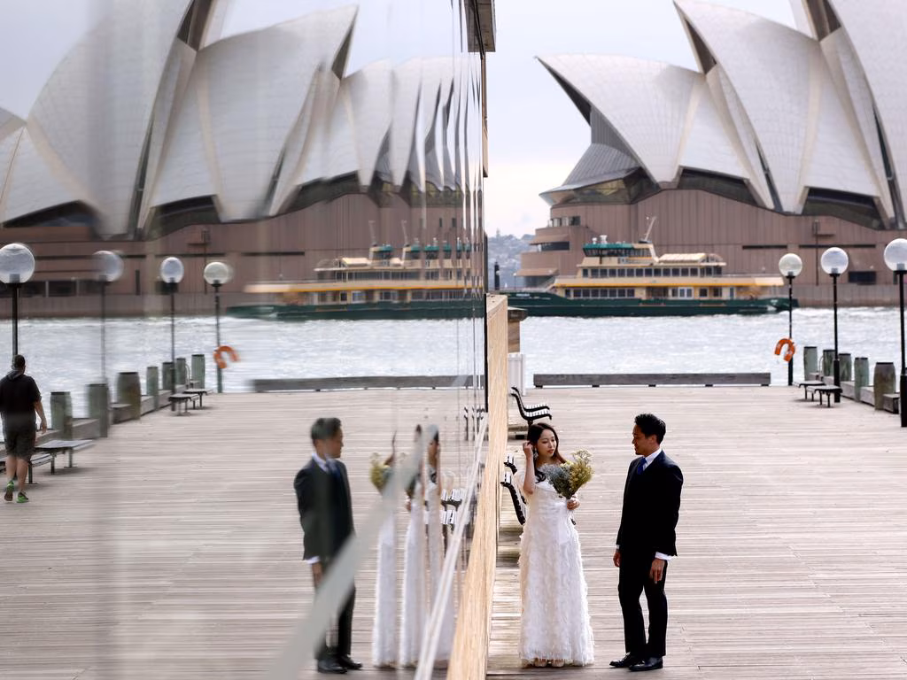 Wedding couple reflecting on the Opera House