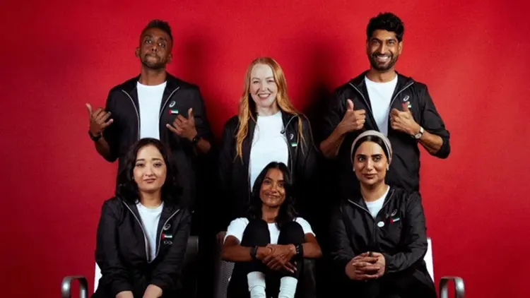 Team of athletes and representatives in branded apparel posing together, highlighting talent representation and professional athlete management services.